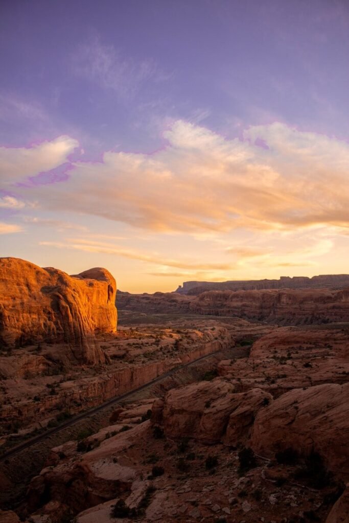 brown rock formation under white clouds during daytime
