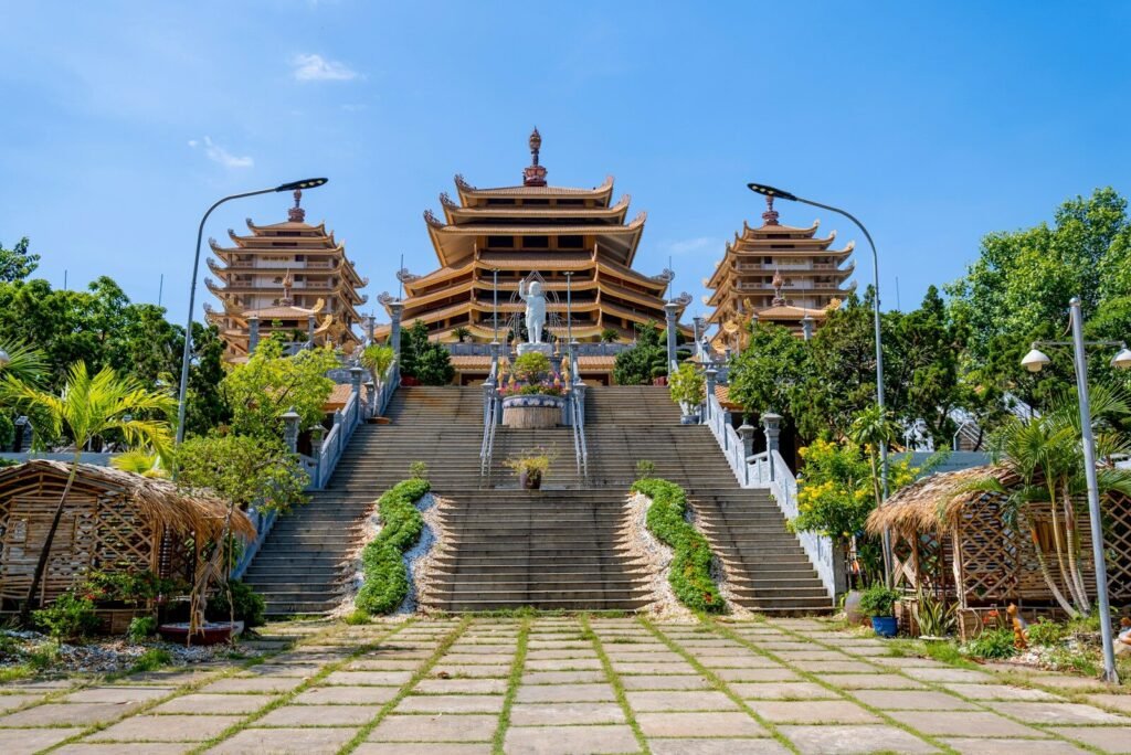 Grand buddhist temple with ornate tiered roofs and stairs.