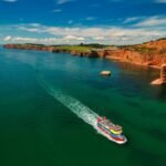 white and red boat on sea during daytime
