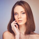 woman with her hand on cheek