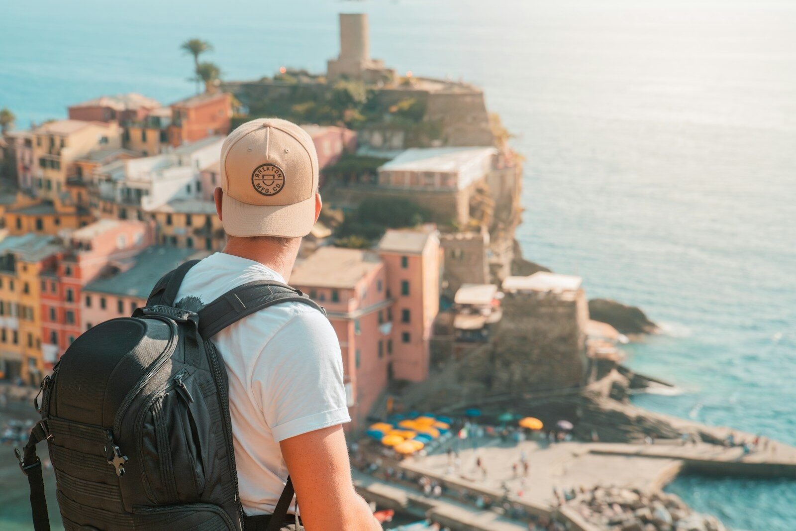 a man with a backpack looking at the ocean